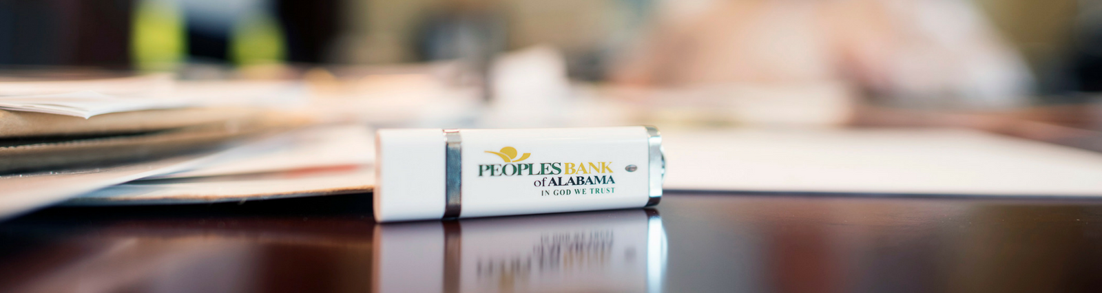 Information Security - Peoples Bank flash drive in focus with blurred background